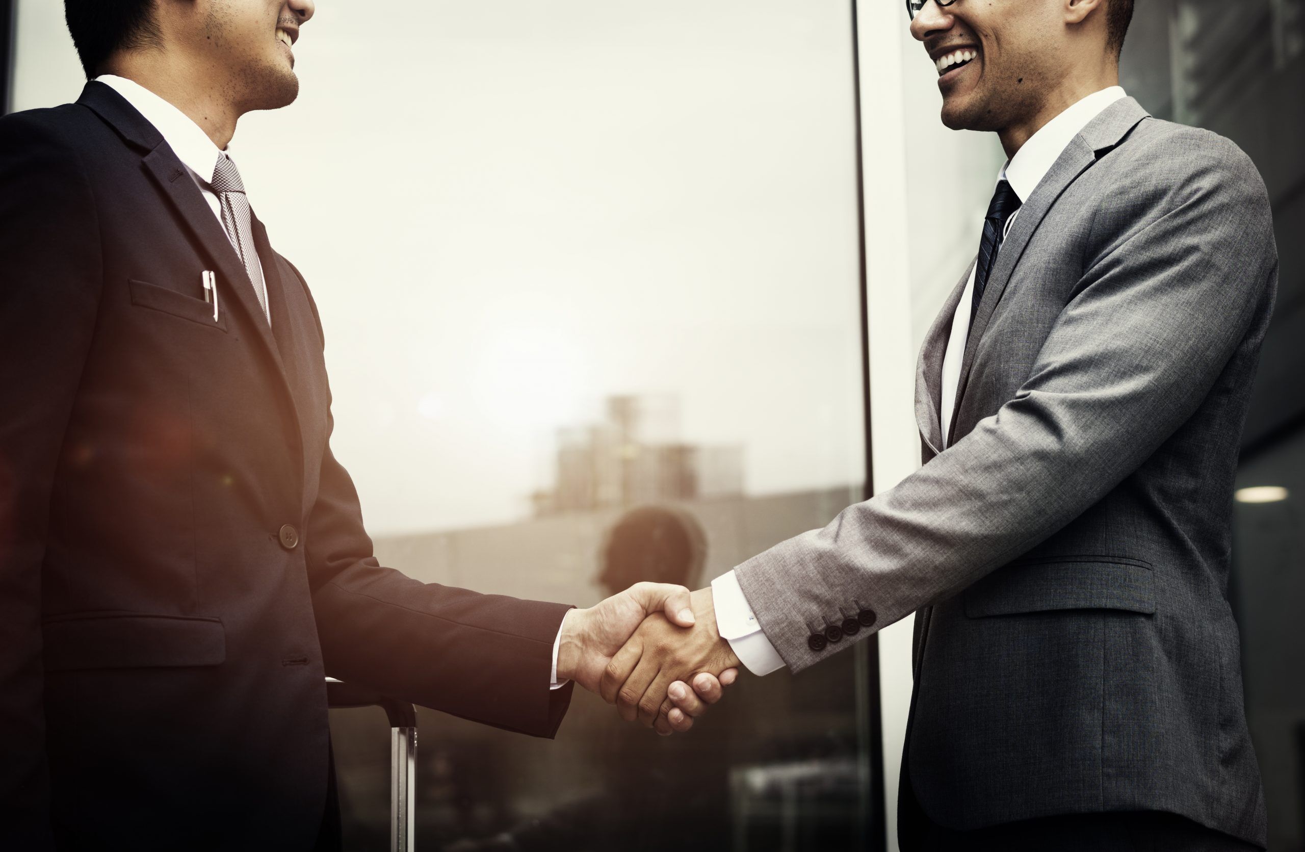Corporate businessmen shaking hands