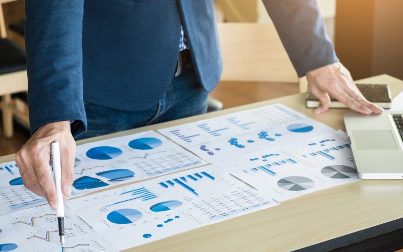 Team work process. young business managers crew working with new startup project. labtop on wood table, typing keyboard, texting message, analyze graph plans.
