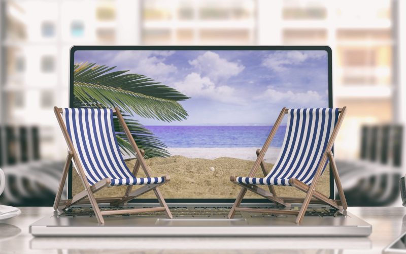 Dreaming summer vacation. Beach chairs on a computer - office background. 3d illustration