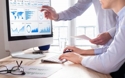 Team of business people discussing digital marketing metrics report and return on investment strategy for advertisement campaign, data analytics dashboard on computer screen in office