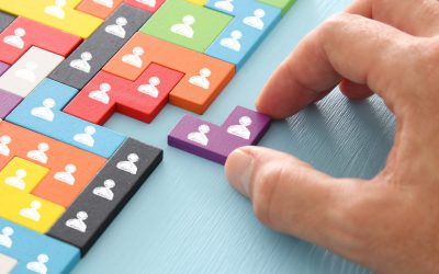 image of tangram puzzle blocks with people icons over wooden table ,human resources and management concept