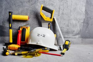 set of construction tools on a black wall background