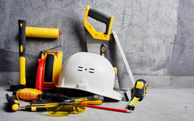 set of construction tools on a black wall background
