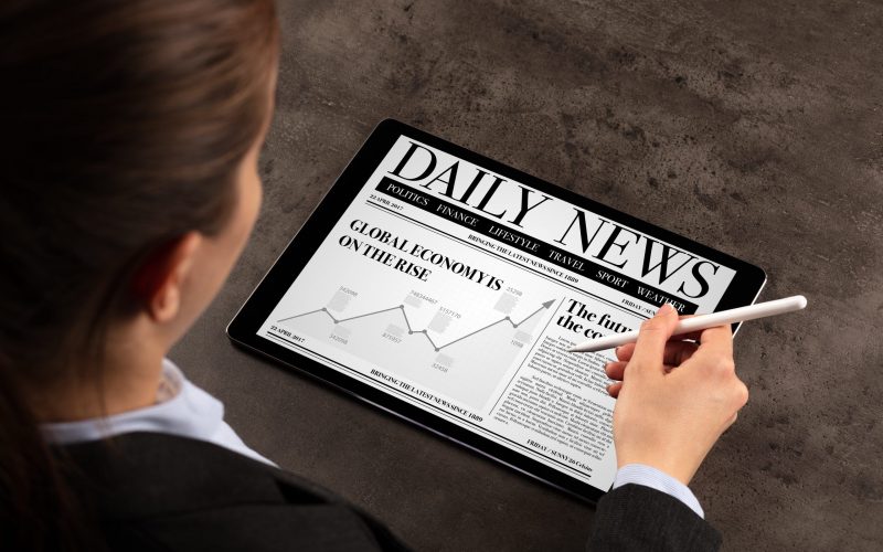 Business woman reading news on tablet