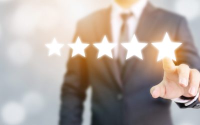 Hand of businessman touching five star symbol to increase rating of company concept